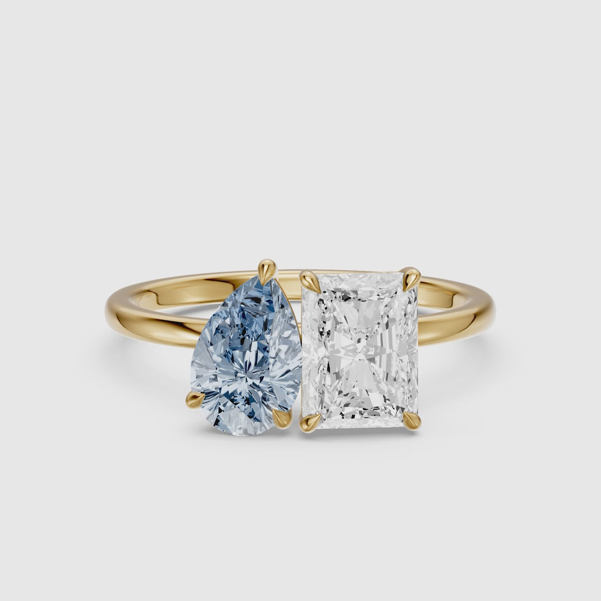 Load video: Eulalia Blue Pear and Radiant Cut Colored Lab Grown Diamond Toi et Moi Ring