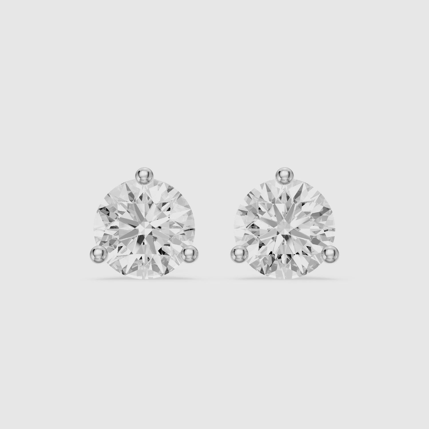 Load video: Gaia Round Cut Lab Grown Diamond Three Prong Martini Stud Earrings