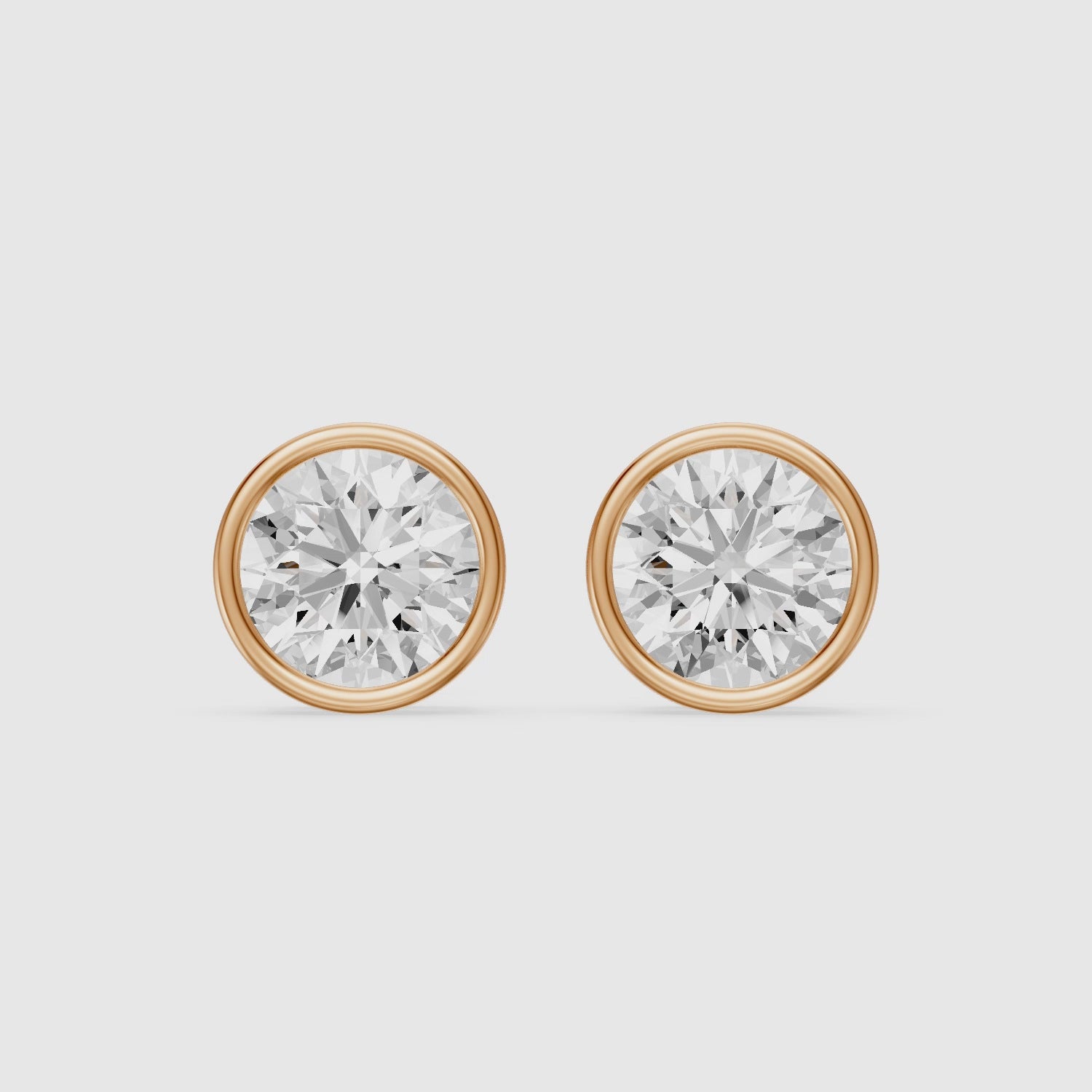 Load video: Lyra Round Cut Lab Grown Diamond Bezel Set Stud Earrings