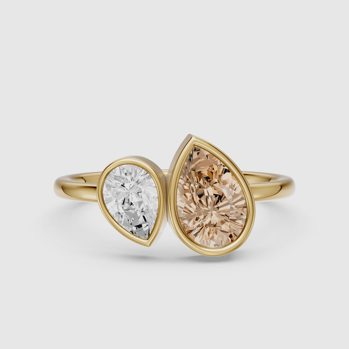 Load video: Ottilie Champagne and White Pear Cut Colored Lab Grown Diamond Toi et Moi Bezel Ring