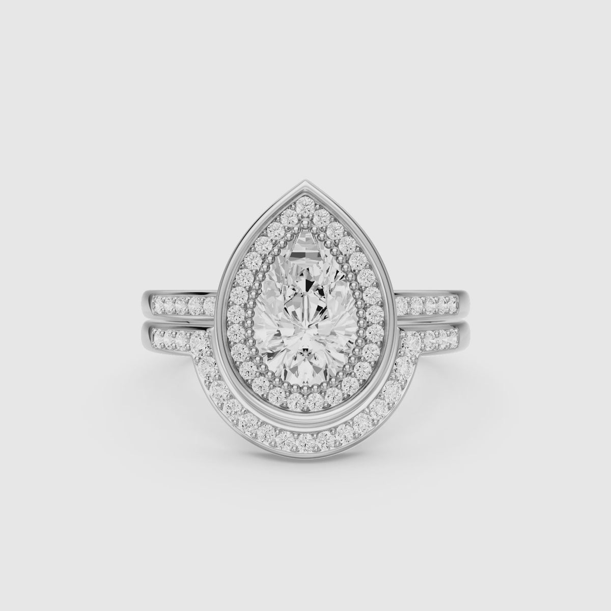 Load video: Cameron Pear Shaped Lab Grown Diamond Halo Bridal Set with Contour Band