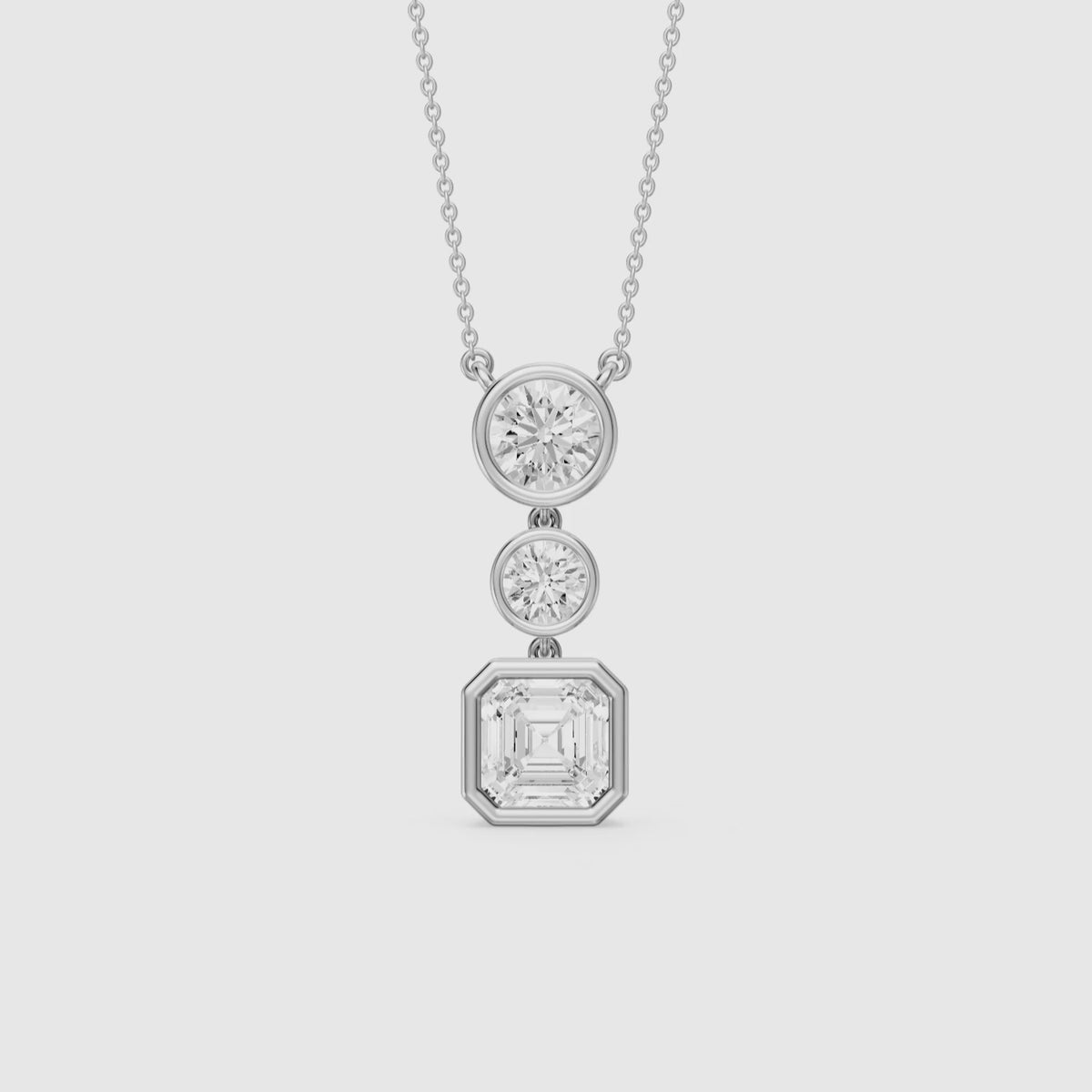 Load video: Vanessa Asscher Cut and Round Cut Lab Grown Diamond Bezel Three Stone Pendant