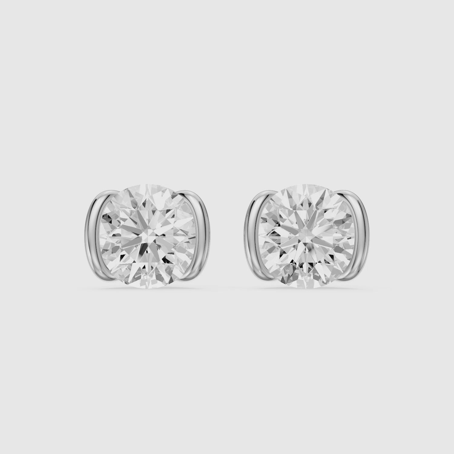 Load video: Aina Round Cut Lab Grown Diamond half Bezel Stud Earrings
