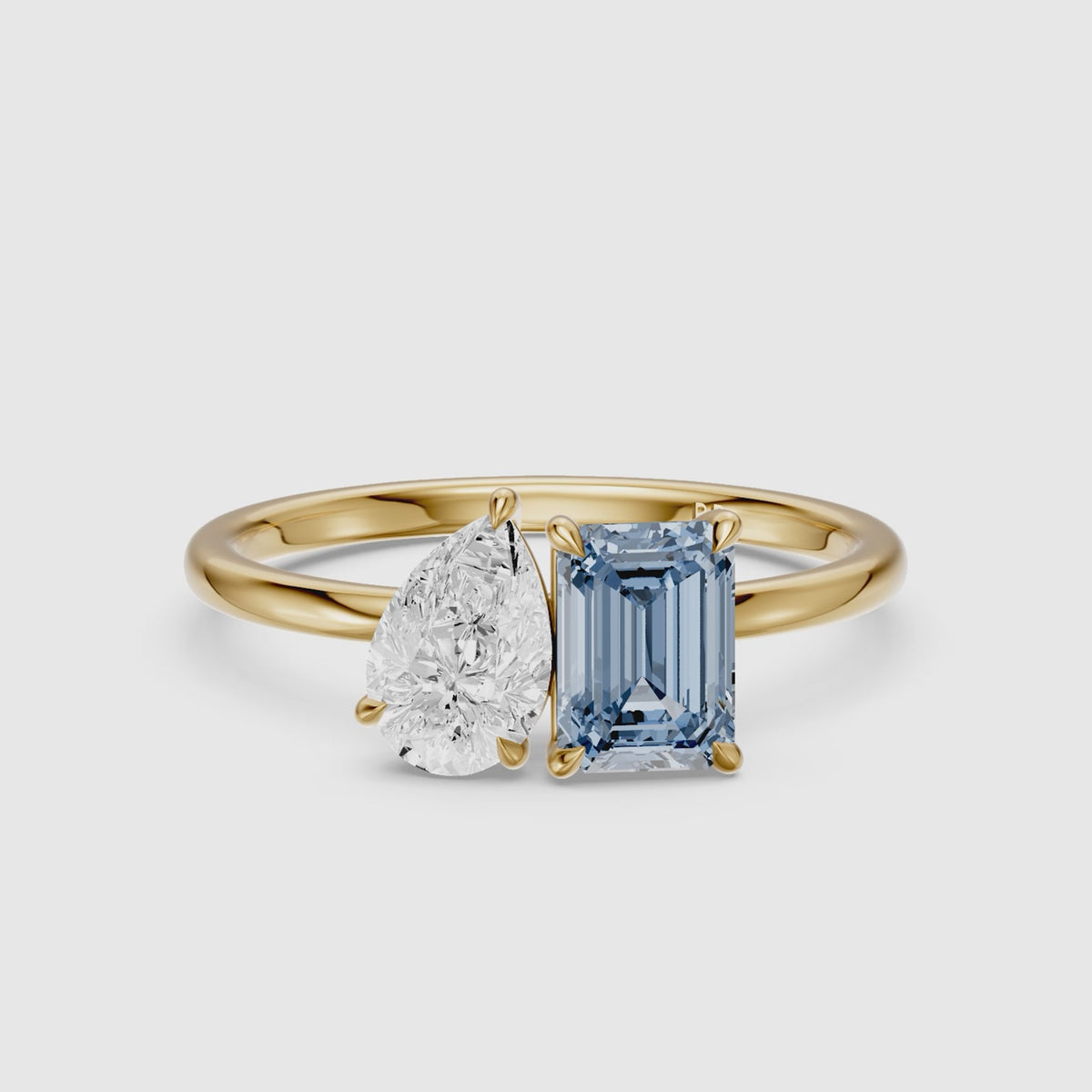 Load video: Runa Blue Emerald Cut and Pear Shape Color Lab Grown Diamond Toi et Moi Ring